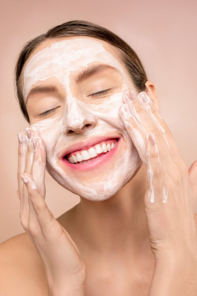 woman with white facial soap on face